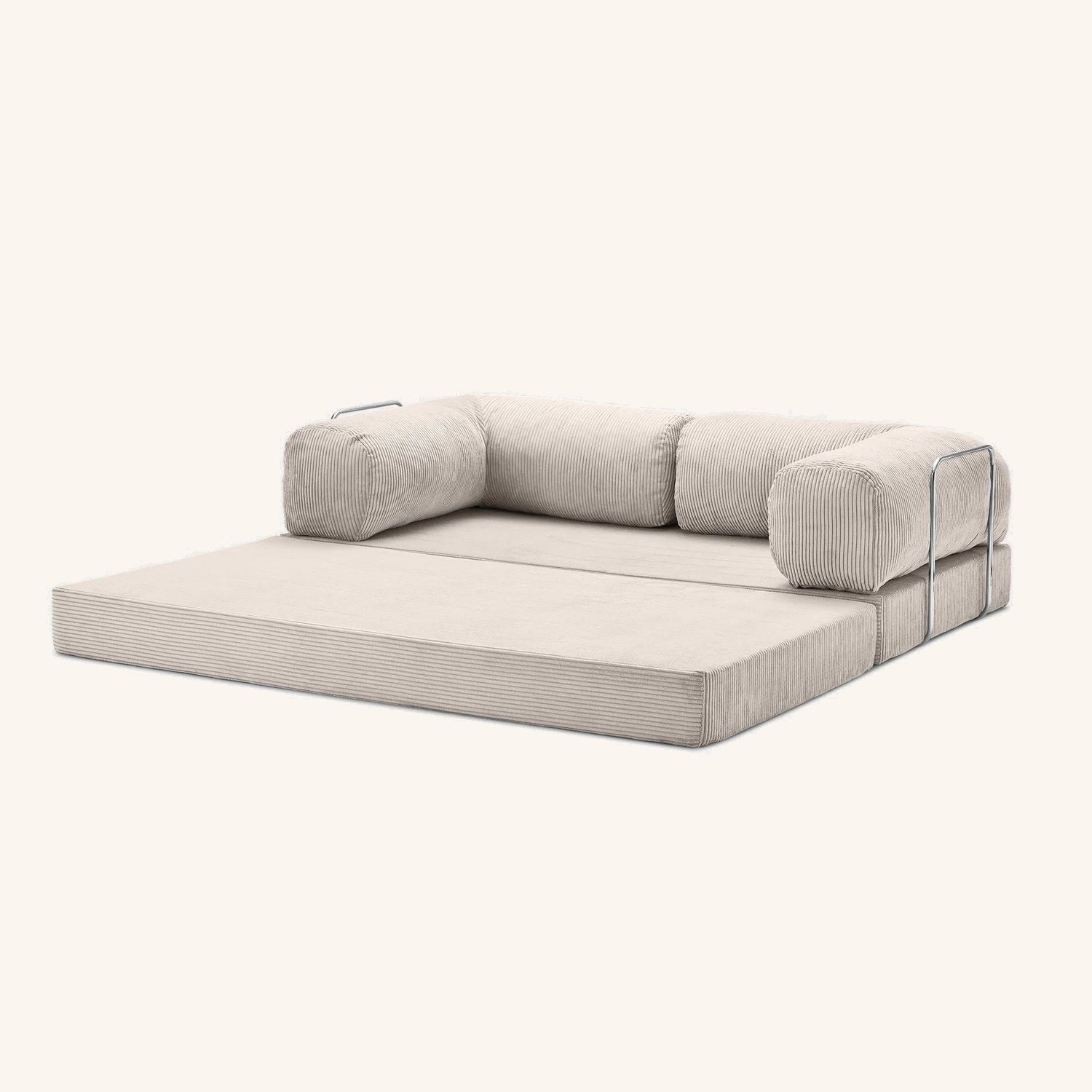 The same Cloud Sofa unfolded flat into a lounge bed, bolsters gathered along the back.